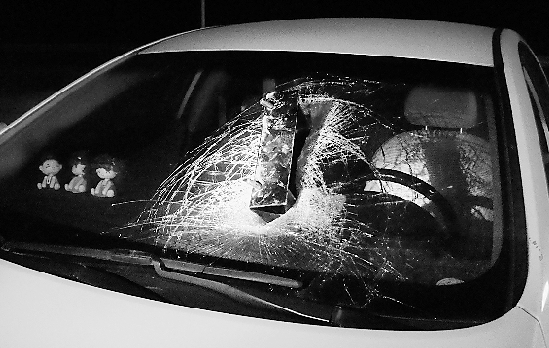 杨先生的轿车前挡风玻璃被砸坏.